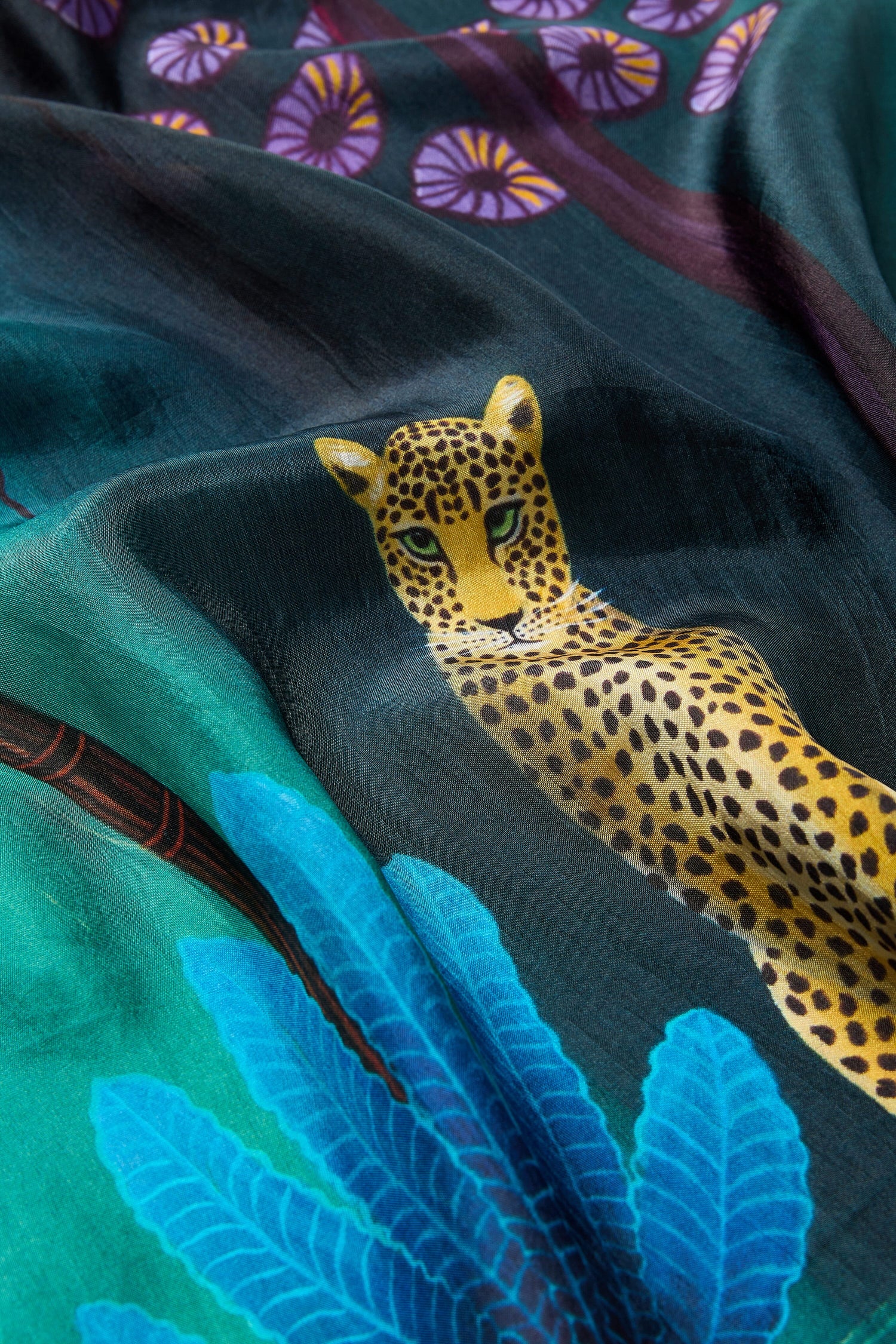 A Twilight Jungle Silk Scarf, sourced ethically, with a leopard on it.