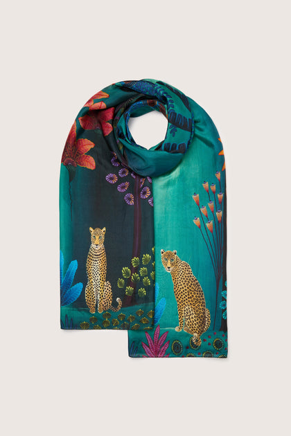 A Twilight Jungle Silk Scarf with a leopard and flowers on it, sourced ethically.