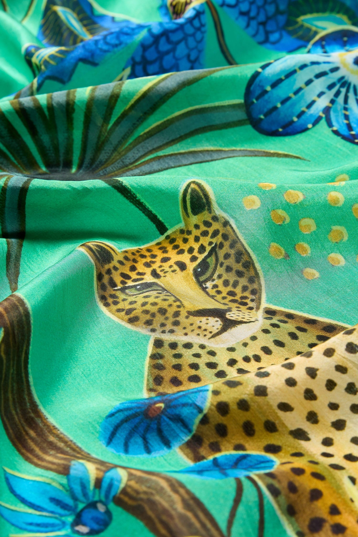 A green Leopard in Moonlight Silk Scarf with flowers on it, ethically sourced materials.