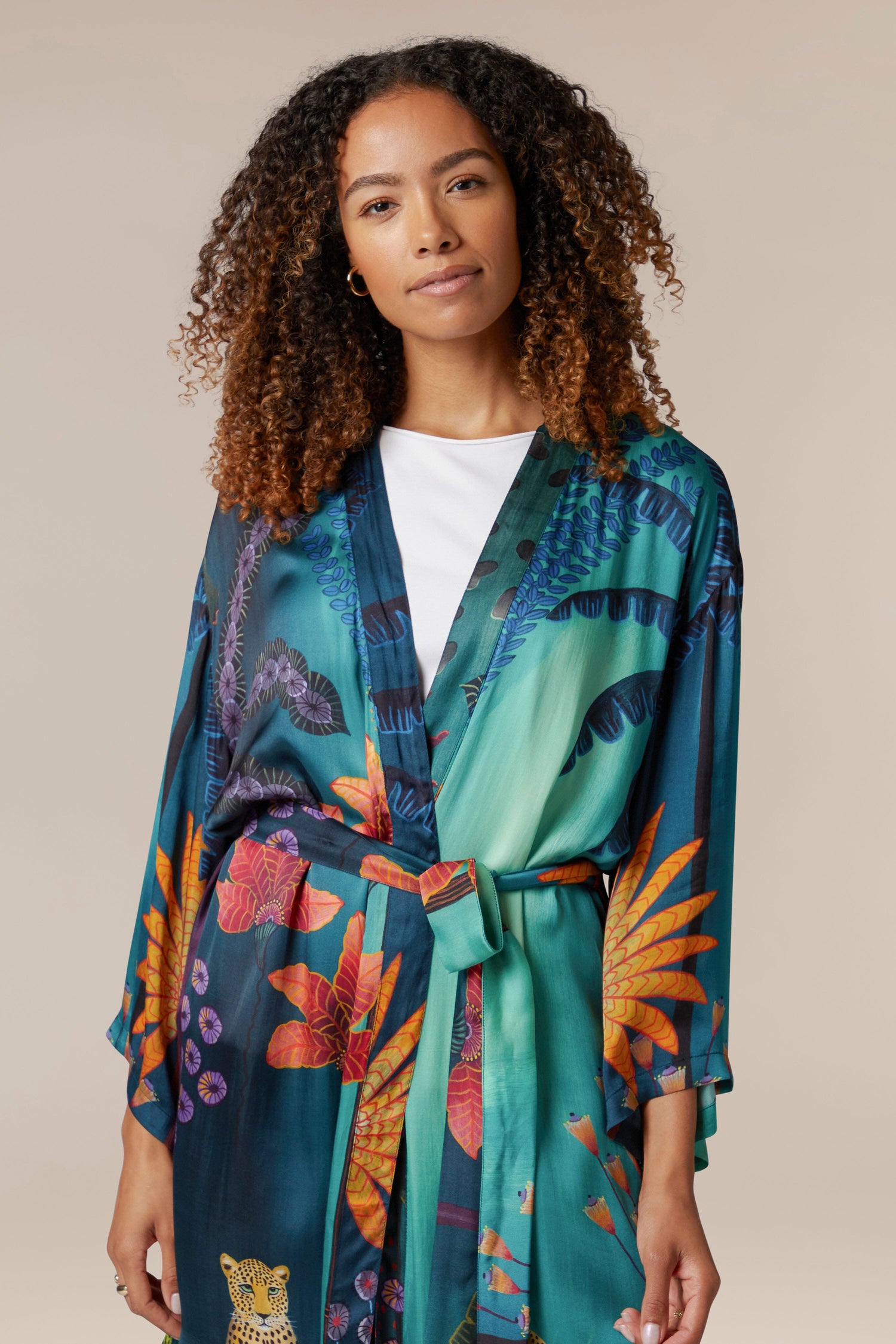 A woman in a Twilight Jungle Gown adorned with an exotic tropical print.