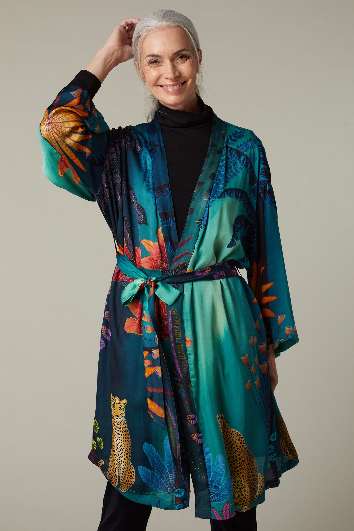 A woman wearing the Twilight Jungle Gown, an exotic kimono with a tropical print.