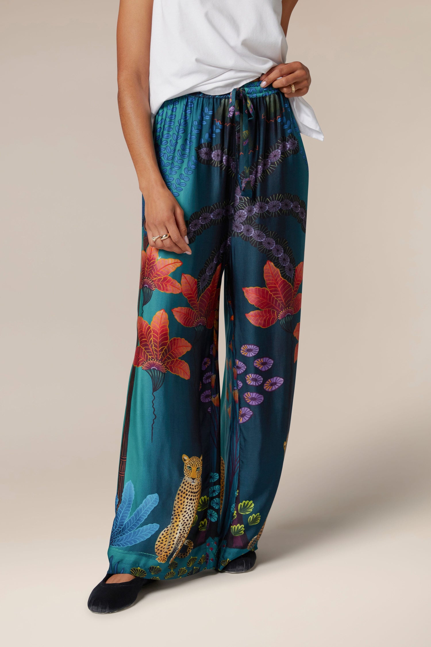 The woman is flaunting a pair of Twilight Jungle Trousers, showcasing the exotic style.