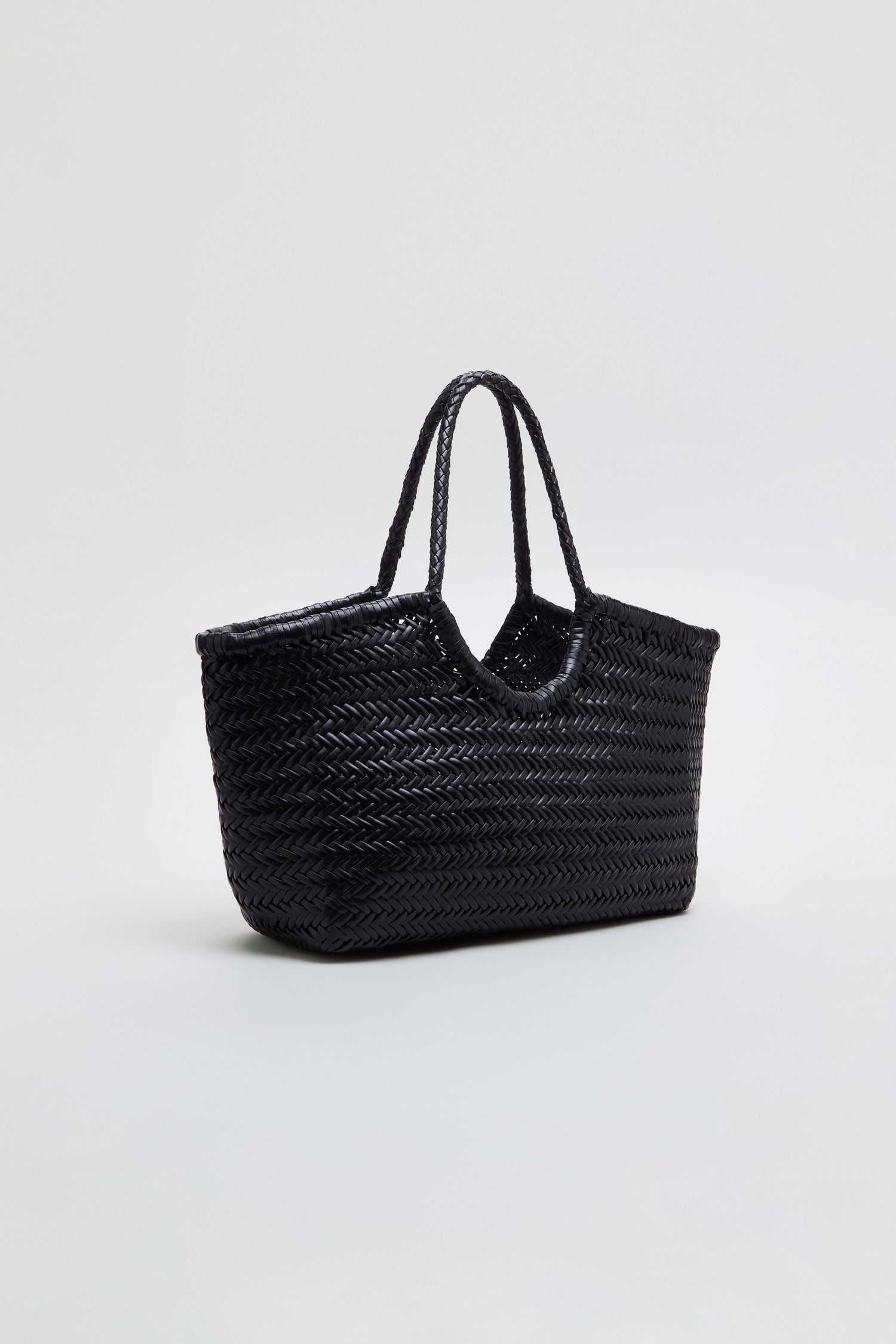 A Nantucket Woven Black Leather Bag, crafted from handwoven buffalo calf leather with two handles, displayed against a plain light background.