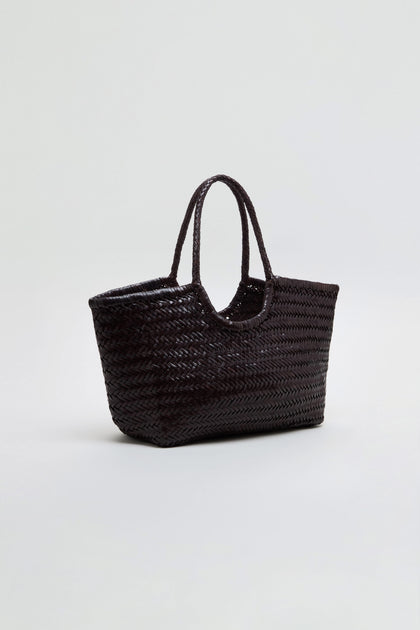 The Nantucket Woven Dark Brown Leather Bag, featuring two handles, is displayed against a plain light background.