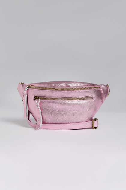 Explore Doris Maroquinerie's newest creation: the Metallic Leather Crossbody Bag, presented in shiny pink iridescent leather. It boasts a main zippered compartment, front zippered pocket, and adjustable strap for a blend of style and functionality.