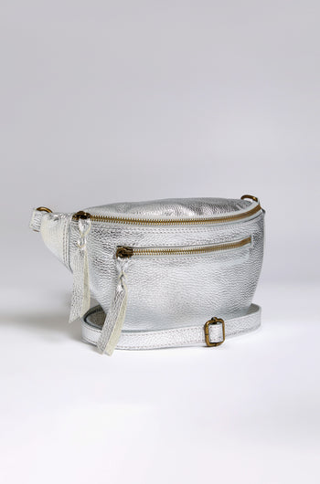 The Metallic Leather Crossbody Bag by Doris Maroquinerie showcases a main zip compartment, a front zip pocket, and tassel accents. Crafted from iridescent leather, it features an adjustable buckle strap for versatile wear.