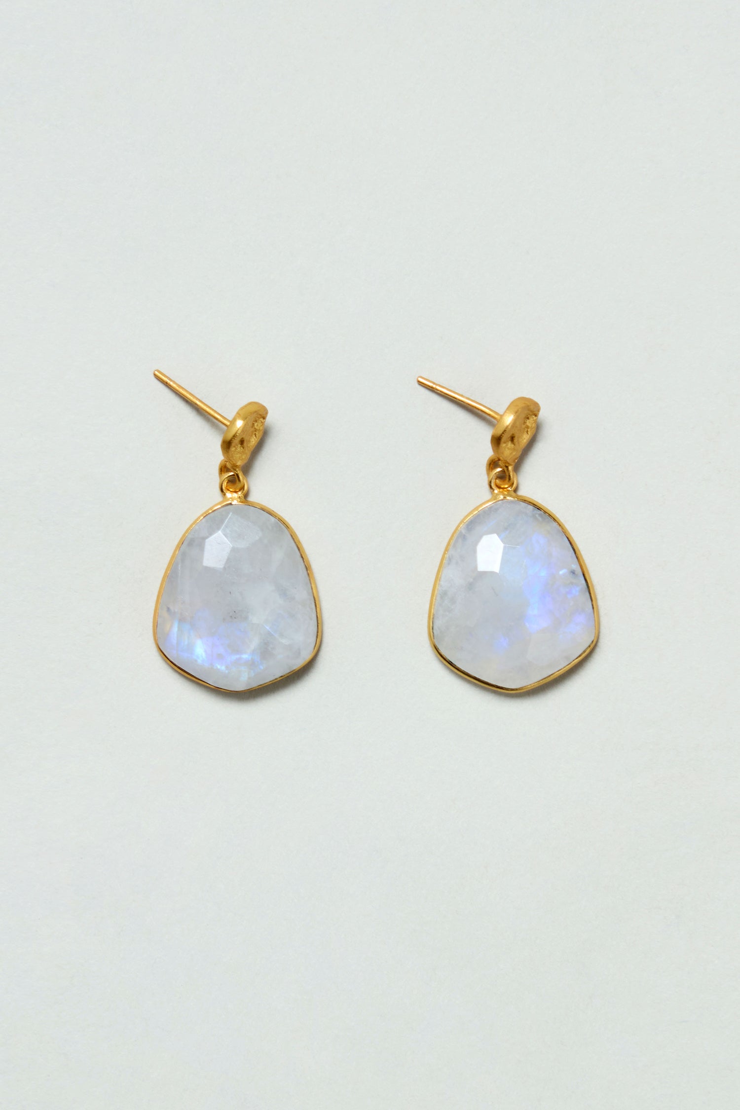 Hand Crafted Rainbow Moonstone Earrings: gold plated, handcrafted earrings with irregular, faceted rainbow moonstones shown on a light background.