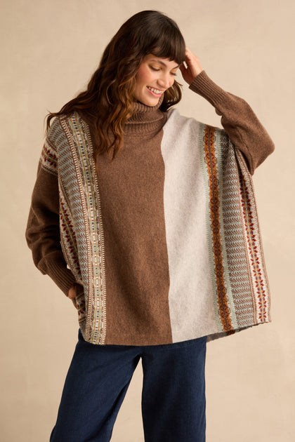Woman wearing a Mushroom Montrose Cowl Neck Sweater featuring a brown and beige Fair Isle pattern, vertical stripes, and ribbed cuffs.