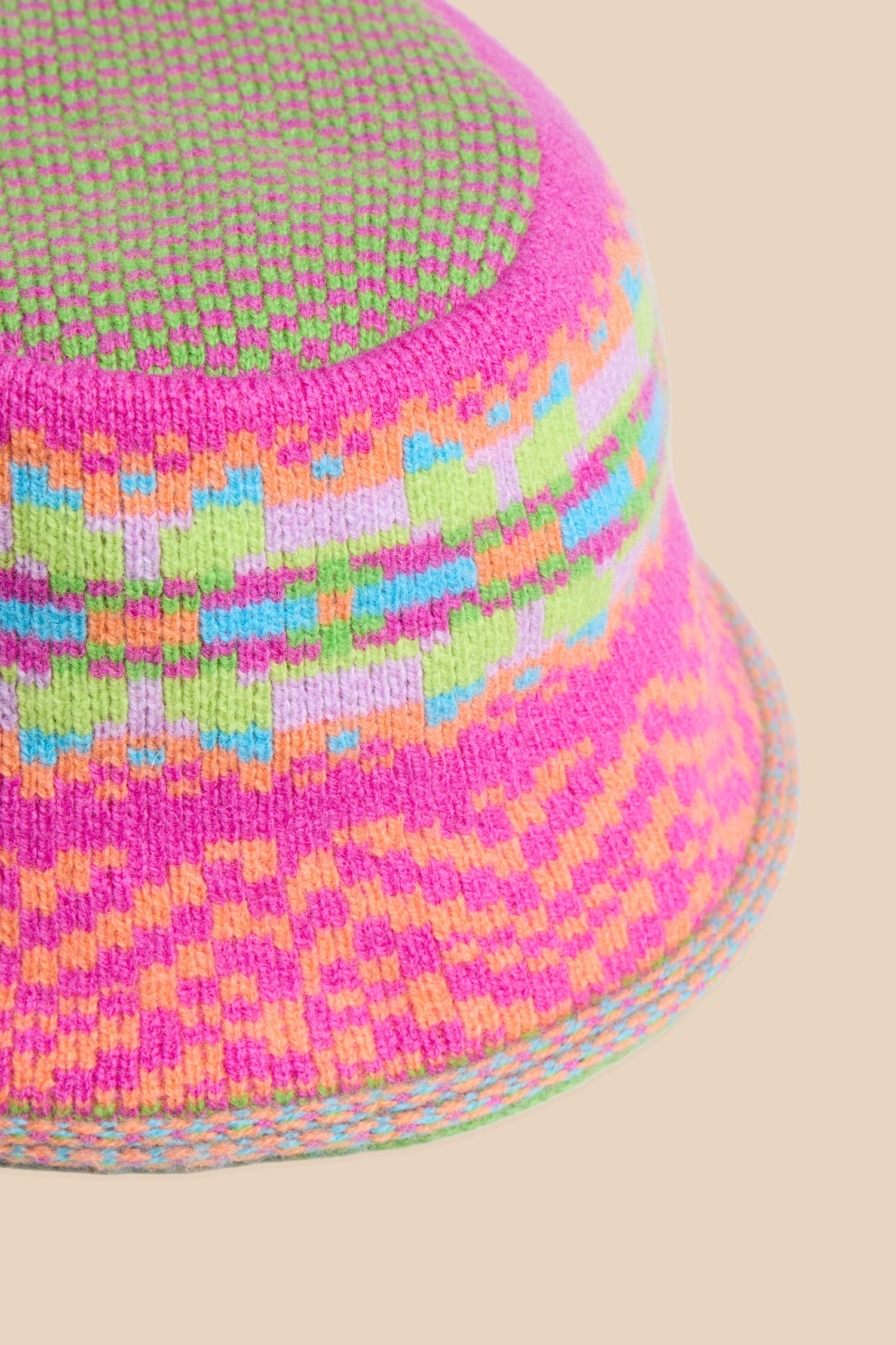 Stobo Graffiti Merino Bucket Hat in a multicoloured Fair Isle knit with a geometric pattern in shades of pink, green, orange, purple, and blue.