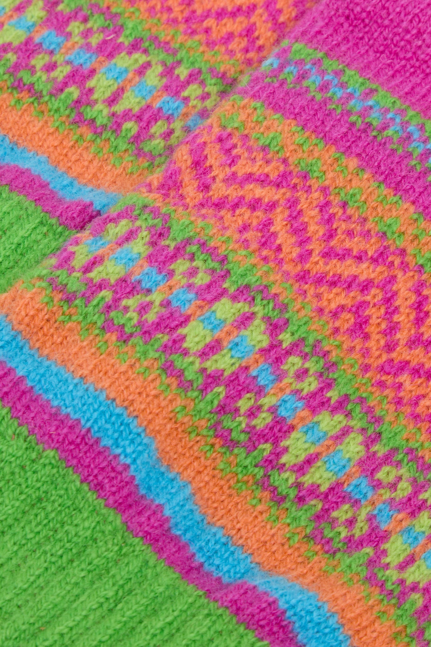 Close-up of Stobo Graffiti Merino Open Mitts featuring a multicolored geometric pattern of pink, orange, green, and blue stripes on fingerless gloves.