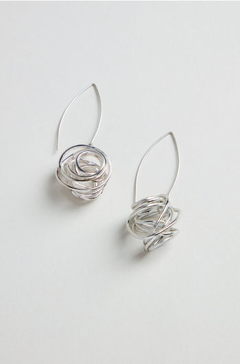 Silver Scribble Earrings—sculptural earrings featuring abstract, nest-like designs—are shown against a plain white background.