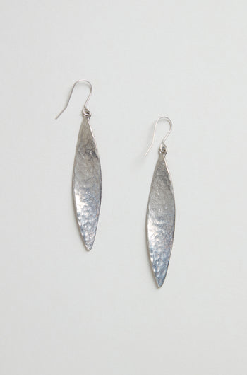 Hammered Silver Leaf Earrings—long, leaf-shaped silver earrings with a textured, hammered finish—shown against a plain light background.