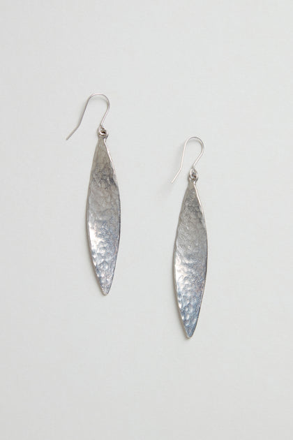 Hammered Silver Leaf Earrings—long, leaf-shaped silver earrings with a textured, hammered finish—shown against a plain light background.