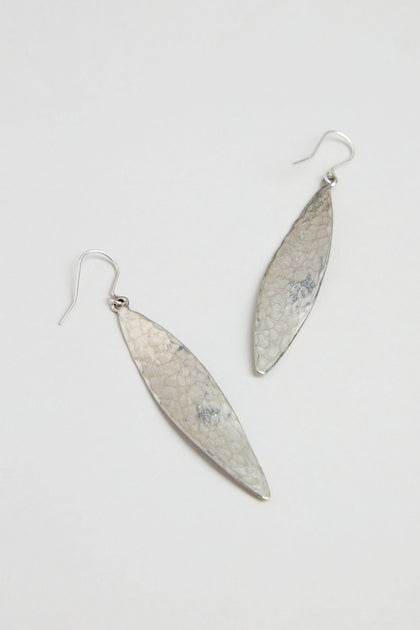 Hammered Silver Leaf Earrings with a textured finish dangle elegantly in a leaf-shaped design against a plain white background.