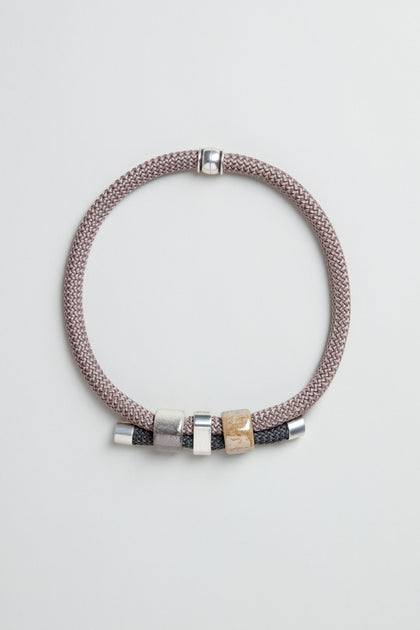 The braided bracelet with silver and gold-tone beads pairs beautifully with the Layered Marble Bead Cord Necklace for an elegant, coordinated look.