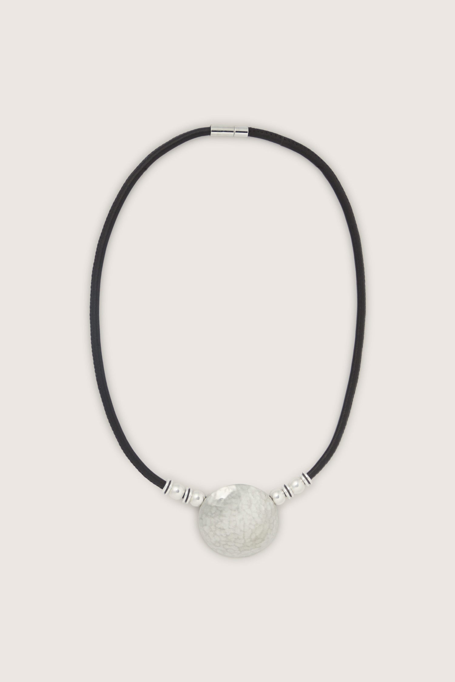 The Mini Hammered Sphere Necklace with a black cord is a stunning piece of jewellery.