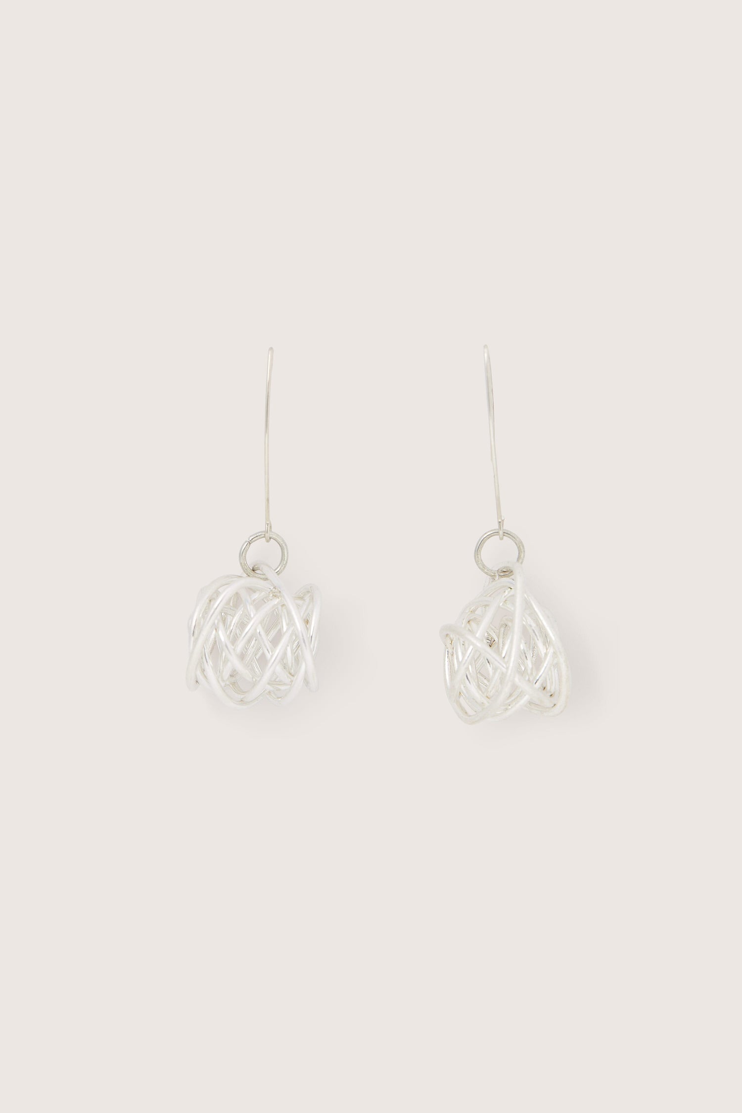 A pair of Silver Squiggle Earrings with twisted wires on a white background.