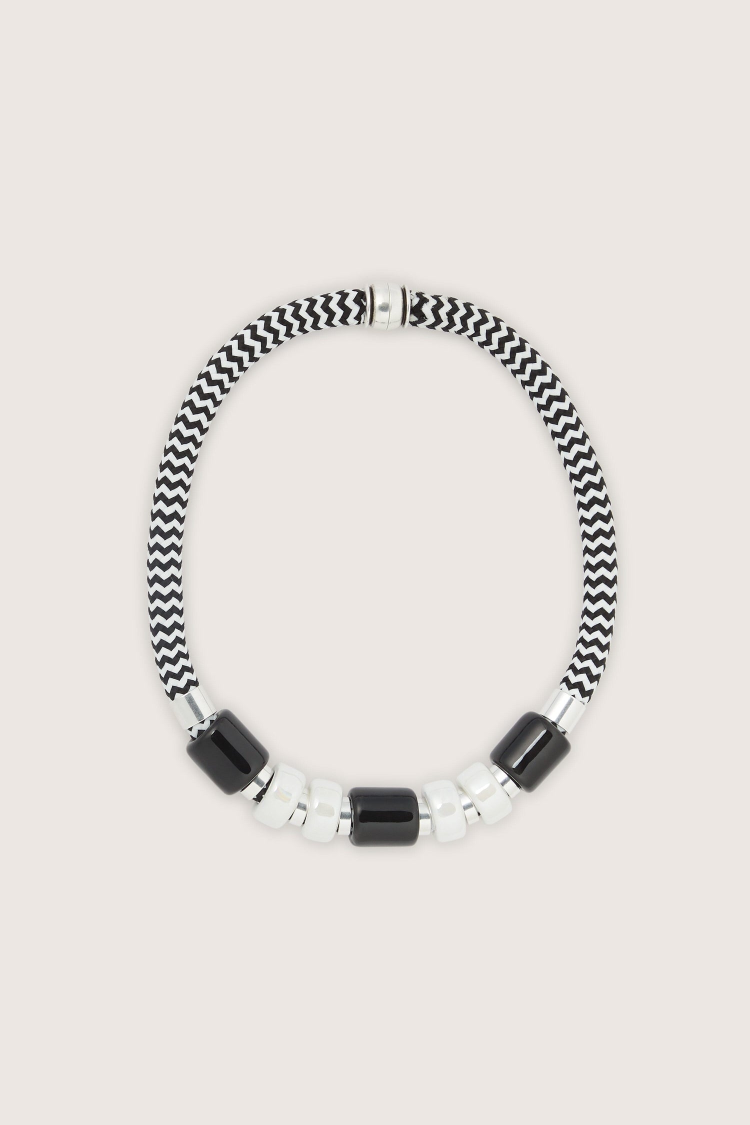 A black and white beaded necklace on a white background, perfect for Etnika jewellery.