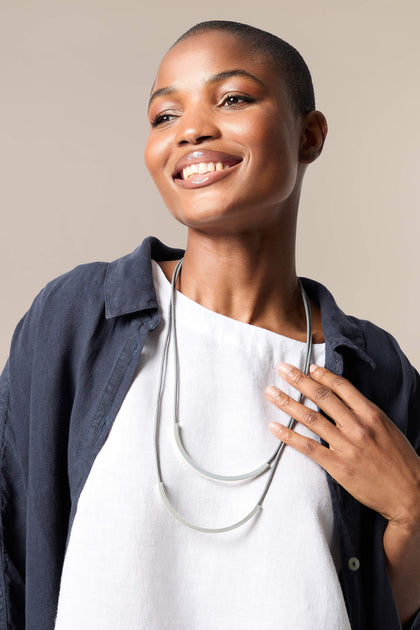 A woman wearing a Double Loop Necklace.