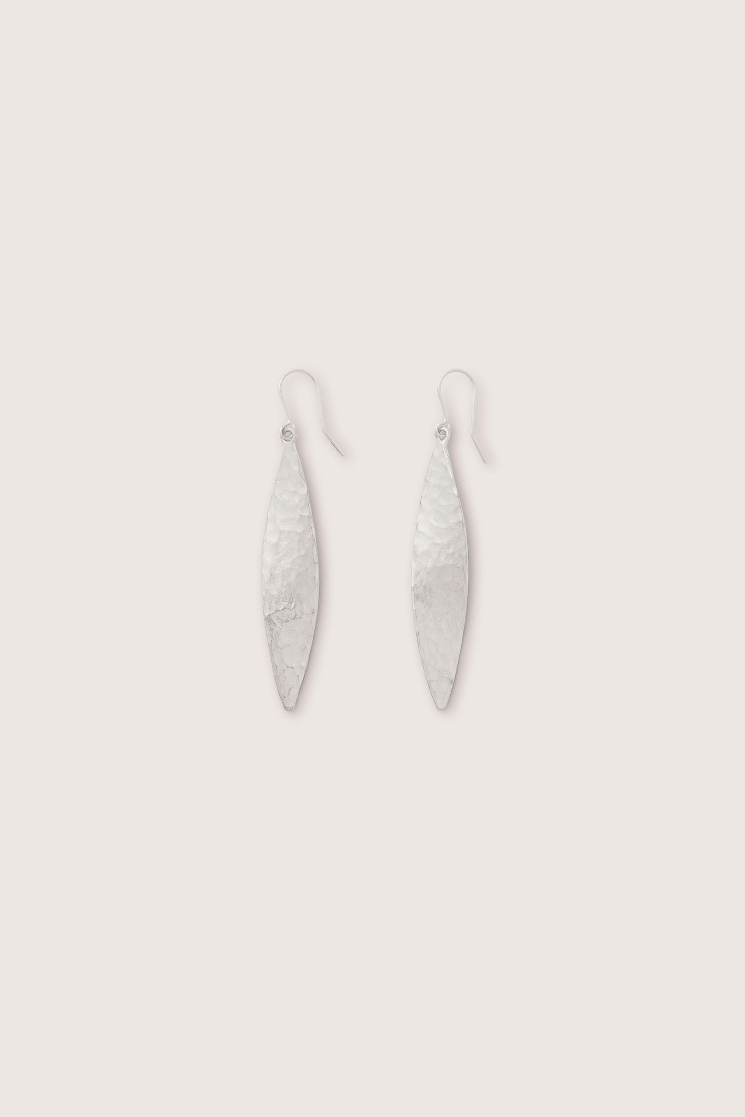 A pair of Hammered Silver Leaf Earrings with hook fastenings set against a plain white background.