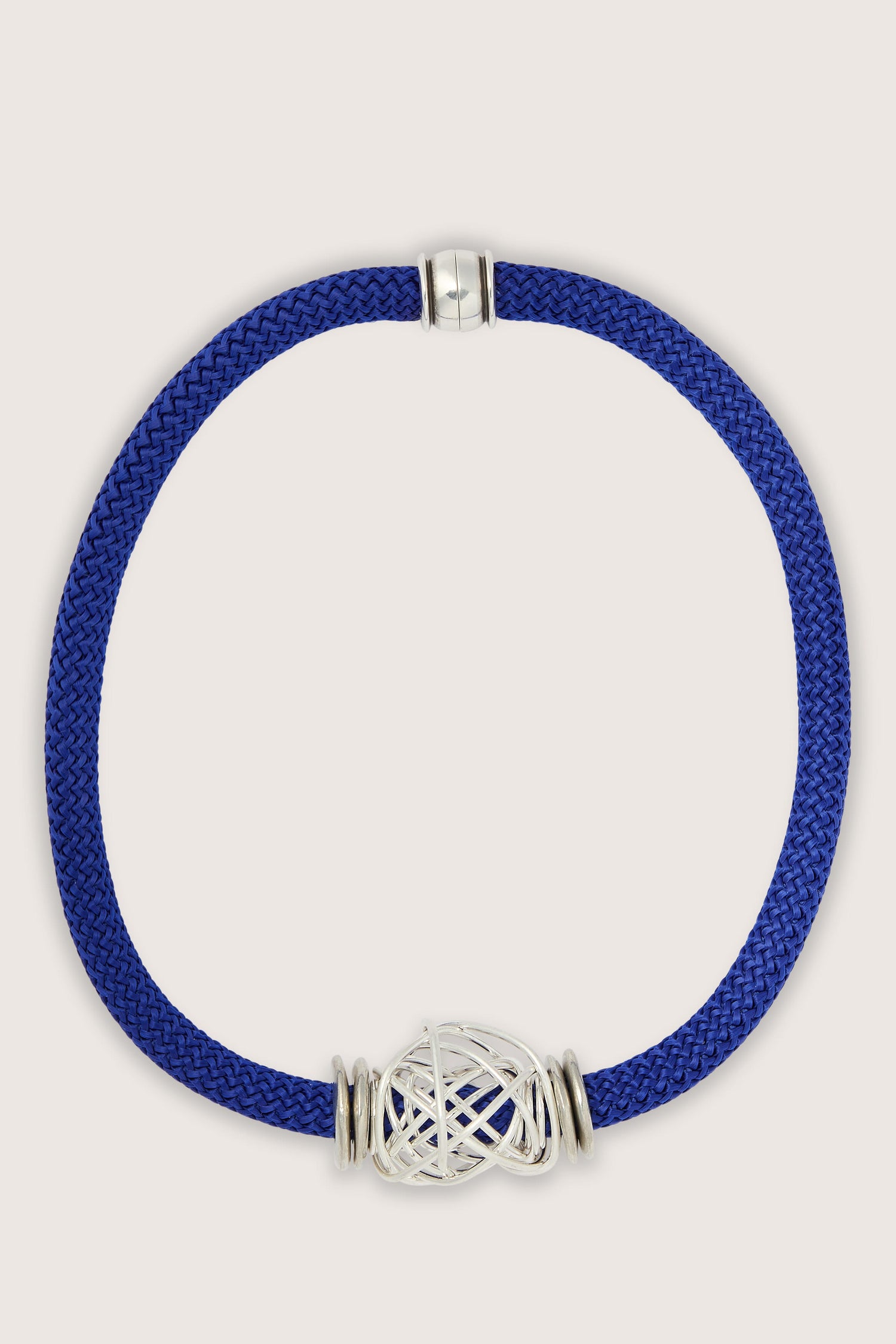 A blue and silver Mini Scribble Cord Necklace with a silver clasp.