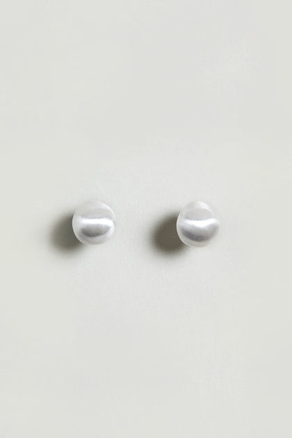 A pair of Mini Silver Pebble Earrings with a subtle silver-tone finish, displayed on a plain light background.