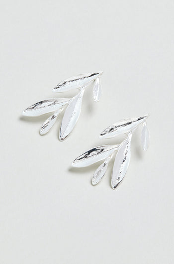 Introducing the Olive Branch Earrings: a pair of elegant silver plated drop earrings with a graceful design featuring three elongated leaves and one small leaf on each earring, beautifully displayed against a light background.