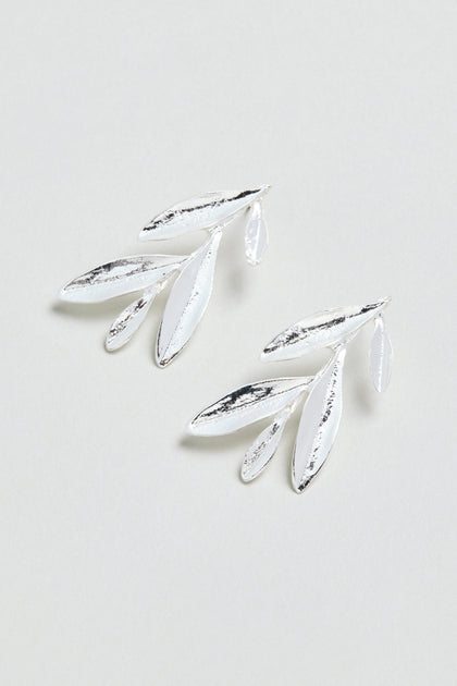 Introducing the Olive Branch Earrings: a pair of elegant silver plated drop earrings with a graceful design featuring three elongated leaves and one small leaf on each earring, beautifully displayed against a light background.