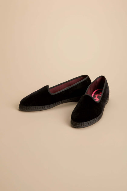 Velvet Slipper Shoes featuring black velvet slip-ons with dark trim and flat, textured recycled rubber soles.