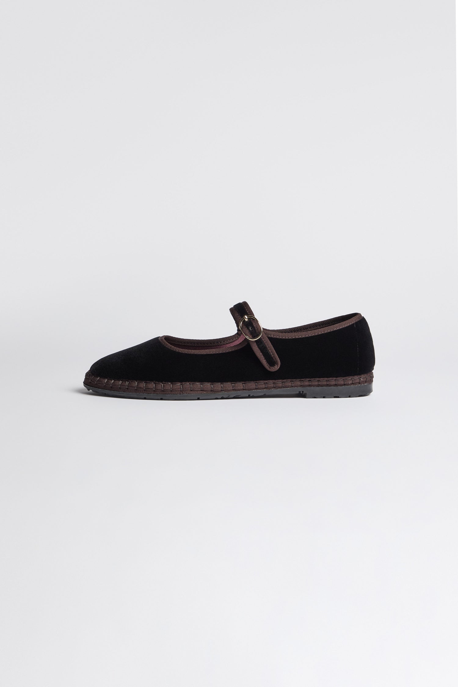 Black Mary Jane Velvet Shoes featuring a single buckle strap and brown trim, crafted with traditional Spanish shoemaking techniques, displayed on a plain light background.