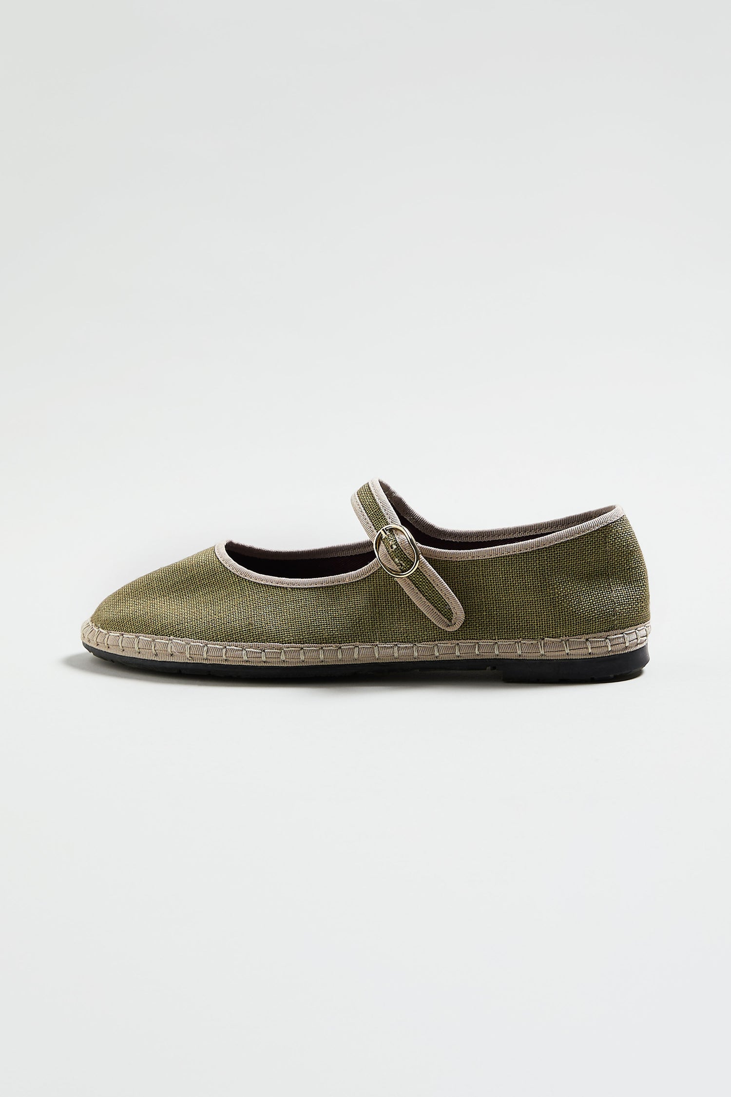 A single green Mary Jane Linen Shoe with a textured upper, round toe, buckle strap, organic cotton lining, and low recycled rubber sole is displayed on a plain white background.