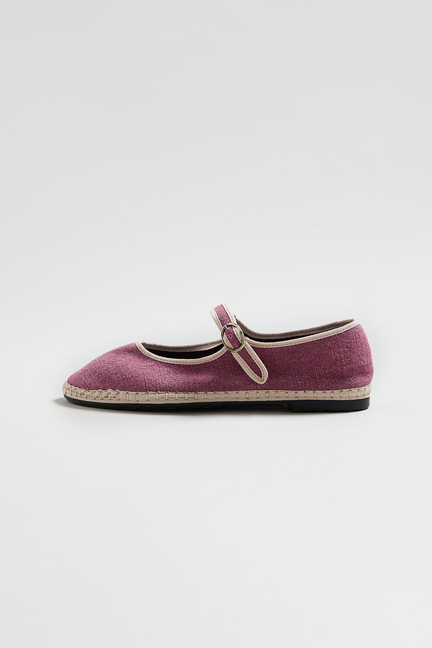 A single Mary Jane Linen Shoe in pink with a buckle strap, off-white trim, and a recycled rubber sole is displayed against a plain light background.