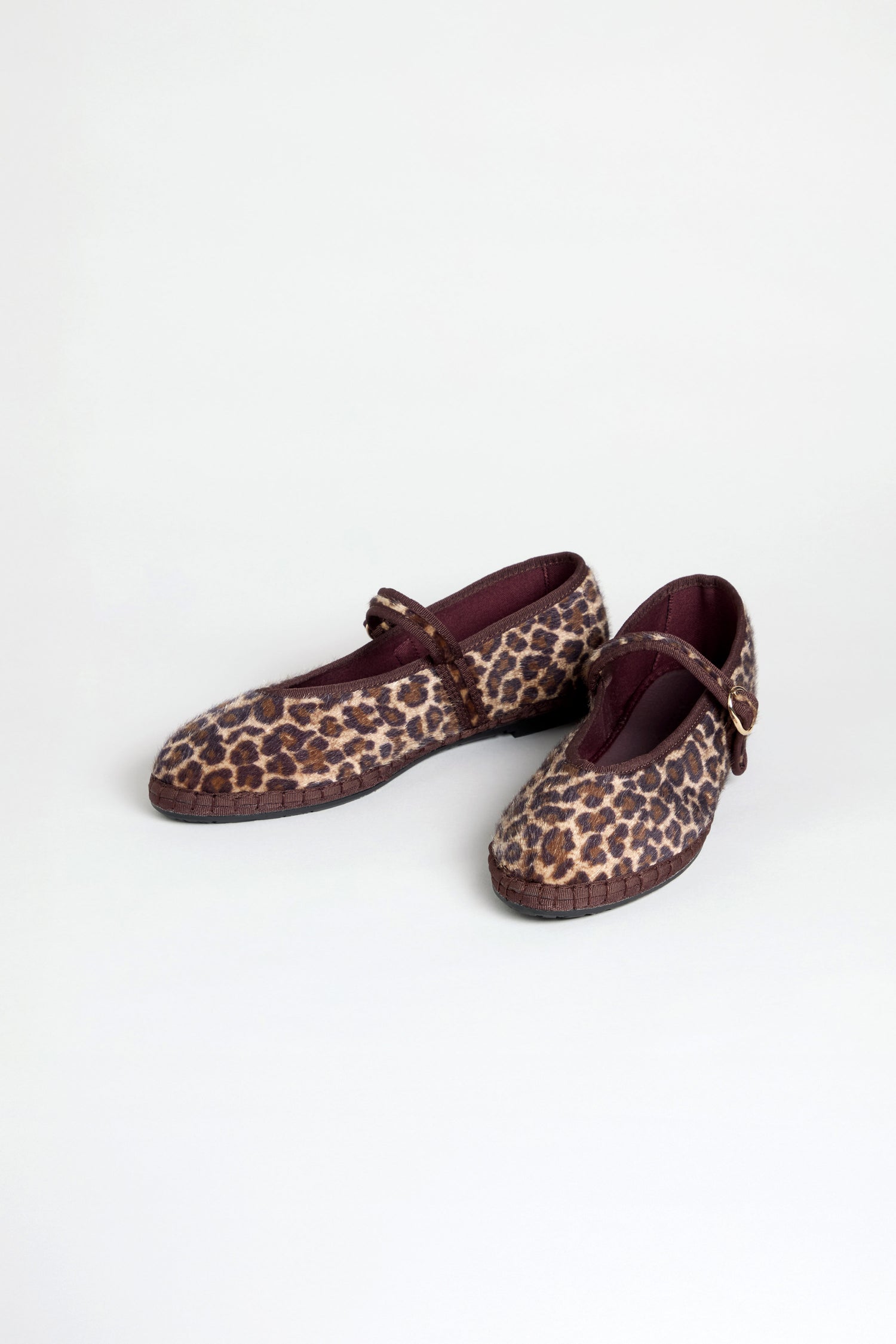 Cheetah Mary Jane Shoes with maroon straps and trim, made with a recycled bicycle tyre sole, are displayed on a plain light background.