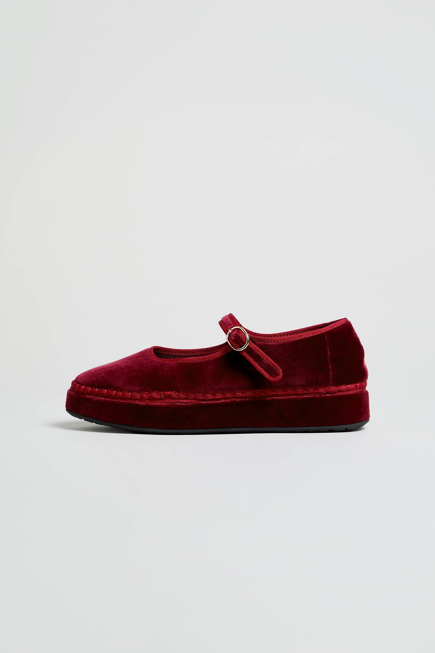 A single Wine Velvet Platform Mary Jane Shoe, featuring a round toe, a platform sole, and a strap secured with a small buckle—handcrafted in Spain—is displayed in profile against a plain light background.
