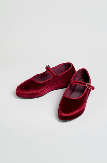 A pair of Wine Velvet Platform Mary Jane Shoes, handmade in Spain with a single strap and flat soles, displayed on a light background.