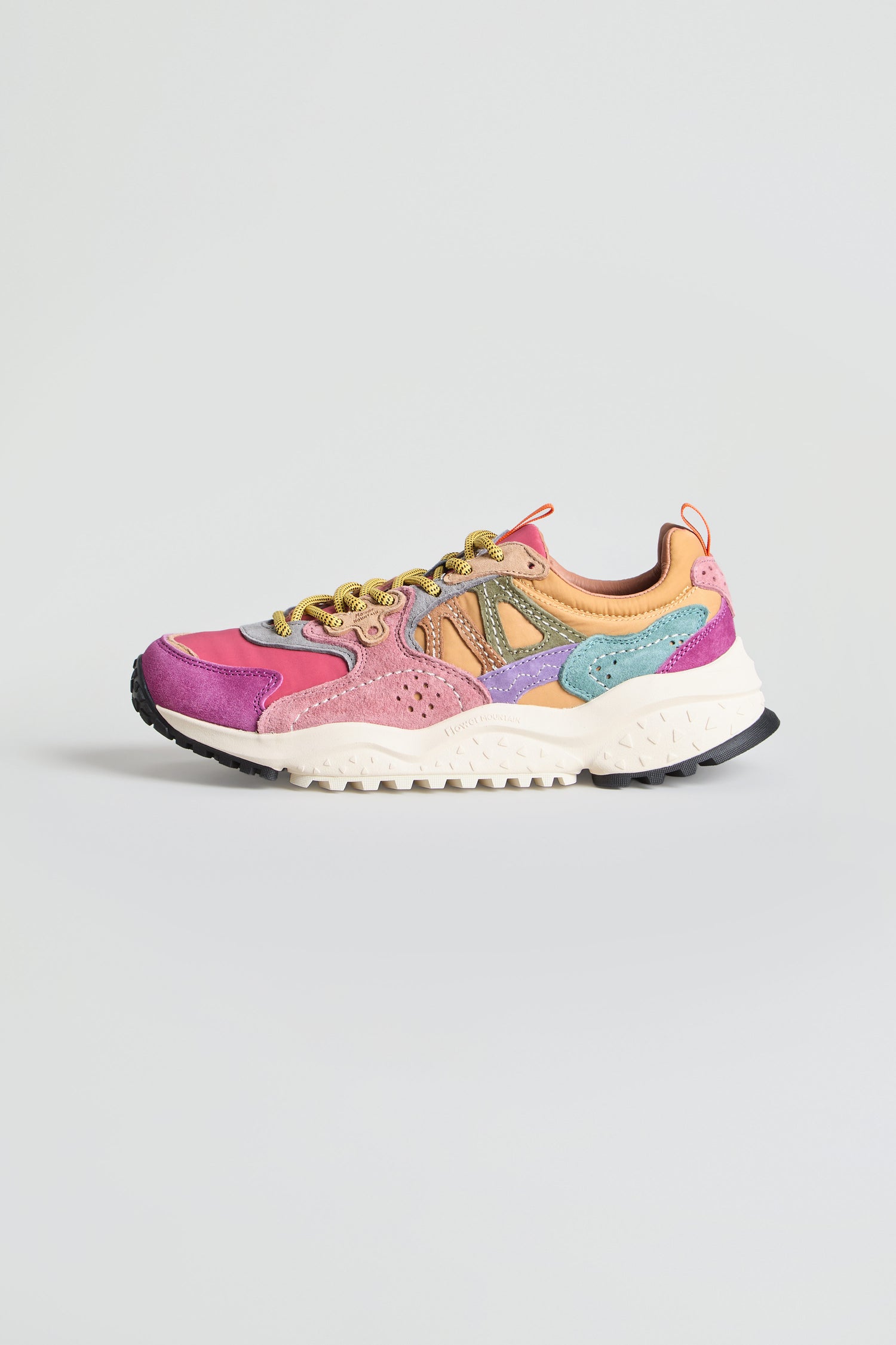 The Solin Colour Pop Trainers are vibrant multicolored sneakers crafted from suede and technical fabric, showcasing bold panels of pink, purple, orange, yellow, and turquoise. Designed with a white sole and black tread for contrast, these trainers capture the energetic style of Flower Mountain footwear. Pictured against a plain light gray background, they offer a true colour pop vibe.