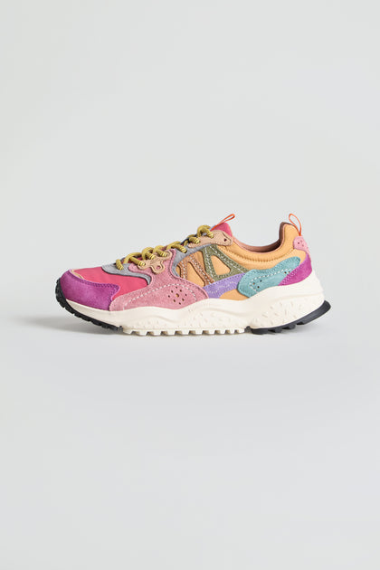 The Solin Colour Pop Trainers are vibrant multicolored sneakers crafted from suede and technical fabric, showcasing bold panels of pink, purple, orange, yellow, and turquoise. Designed with a white sole and black tread for contrast, these trainers capture the energetic style of Flower Mountain footwear. Pictured against a plain light gray background, they offer a true colour pop vibe.