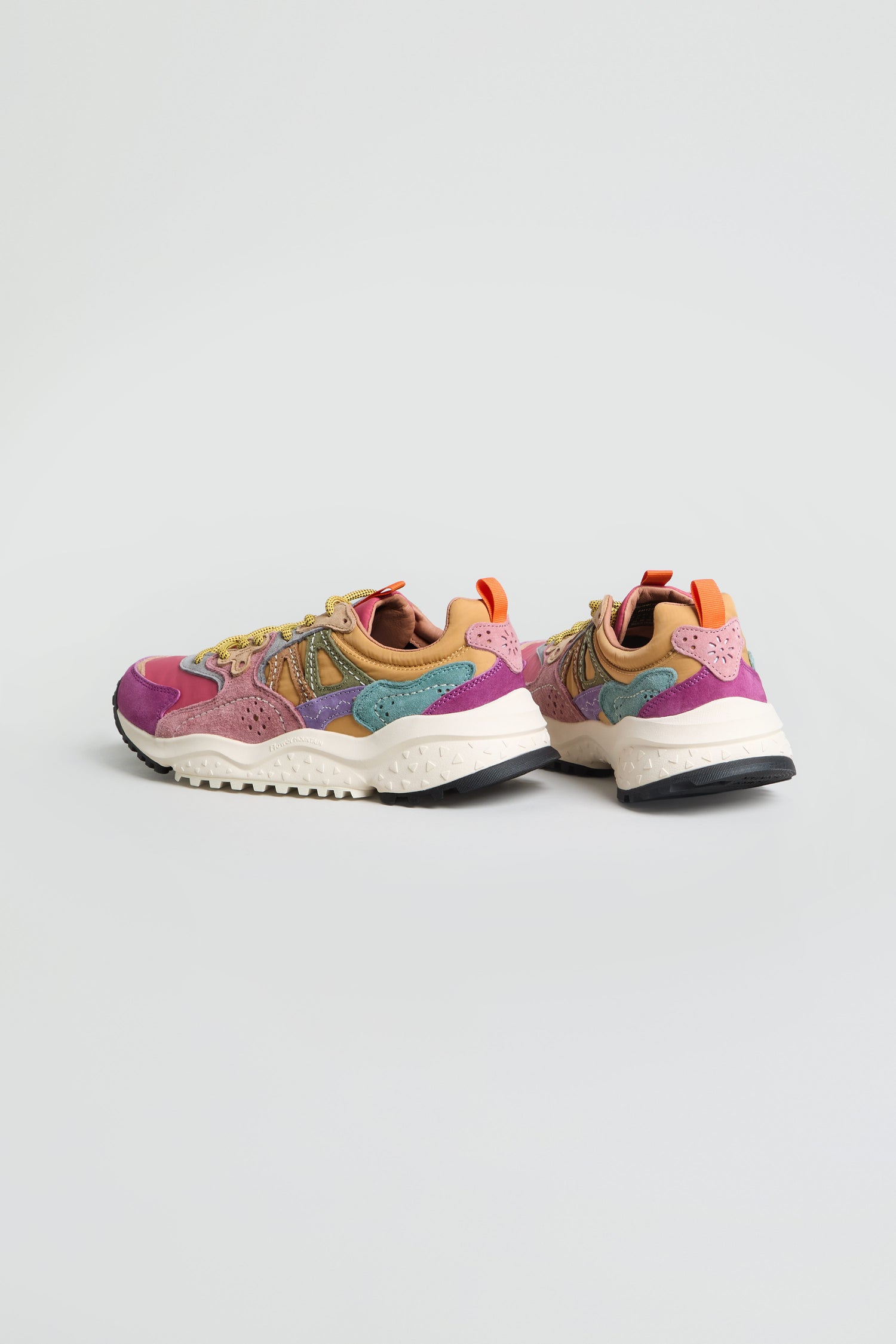 Add a burst of color to your collection with the Solin Colour Pop Trainers—crafted from suede and technical fabric with vibrant pink, purple, teal, tan, and orange accents on a white base. One shoe faces forward while the other is angled outward, showcasing their standout design.