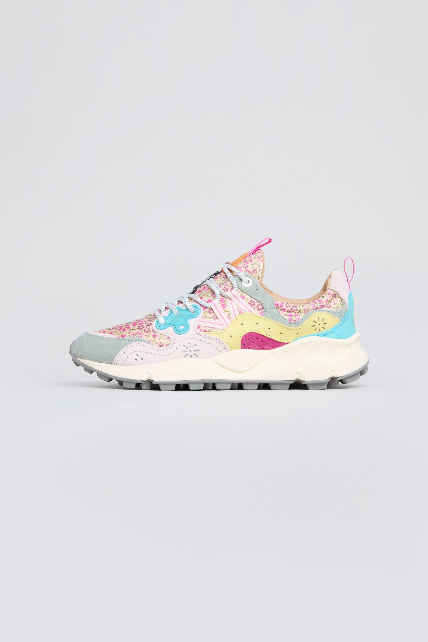 The Yamano 3 Floral Suede Nylon Trainers feature a multicolored floral pattern, blue laces, and a white sole, combining trekking-inspired design with vibrant suede accents, shown on a simple light background.