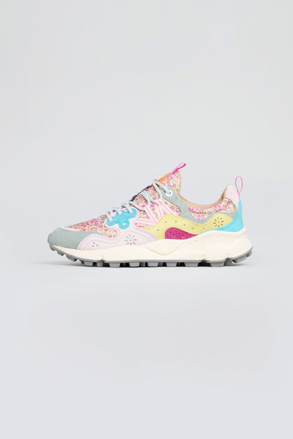 The Yamano 3 Floral Suede Nylon Trainers feature a multicolored floral pattern, blue laces, and a white sole, combining trekking-inspired design with vibrant suede accents, shown on a simple light background.