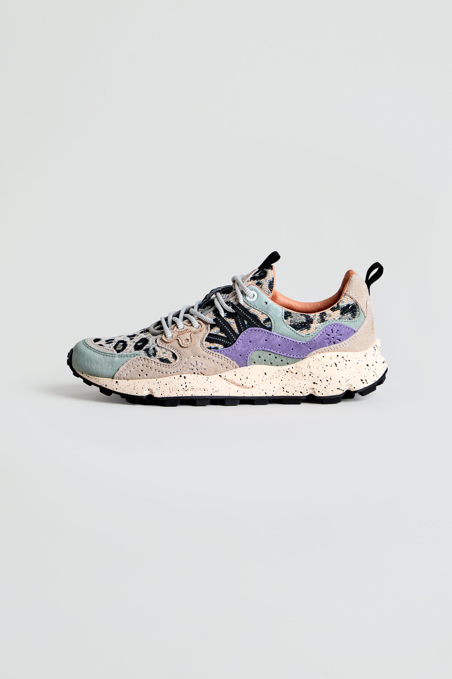 The Yamano 3 Leopard Print Trainers feature a vibrant leopard print design, a chunky beige speckled sole, purple side detailing, black laces, and a black heel pull tab, and are showcased against a plain light background.
