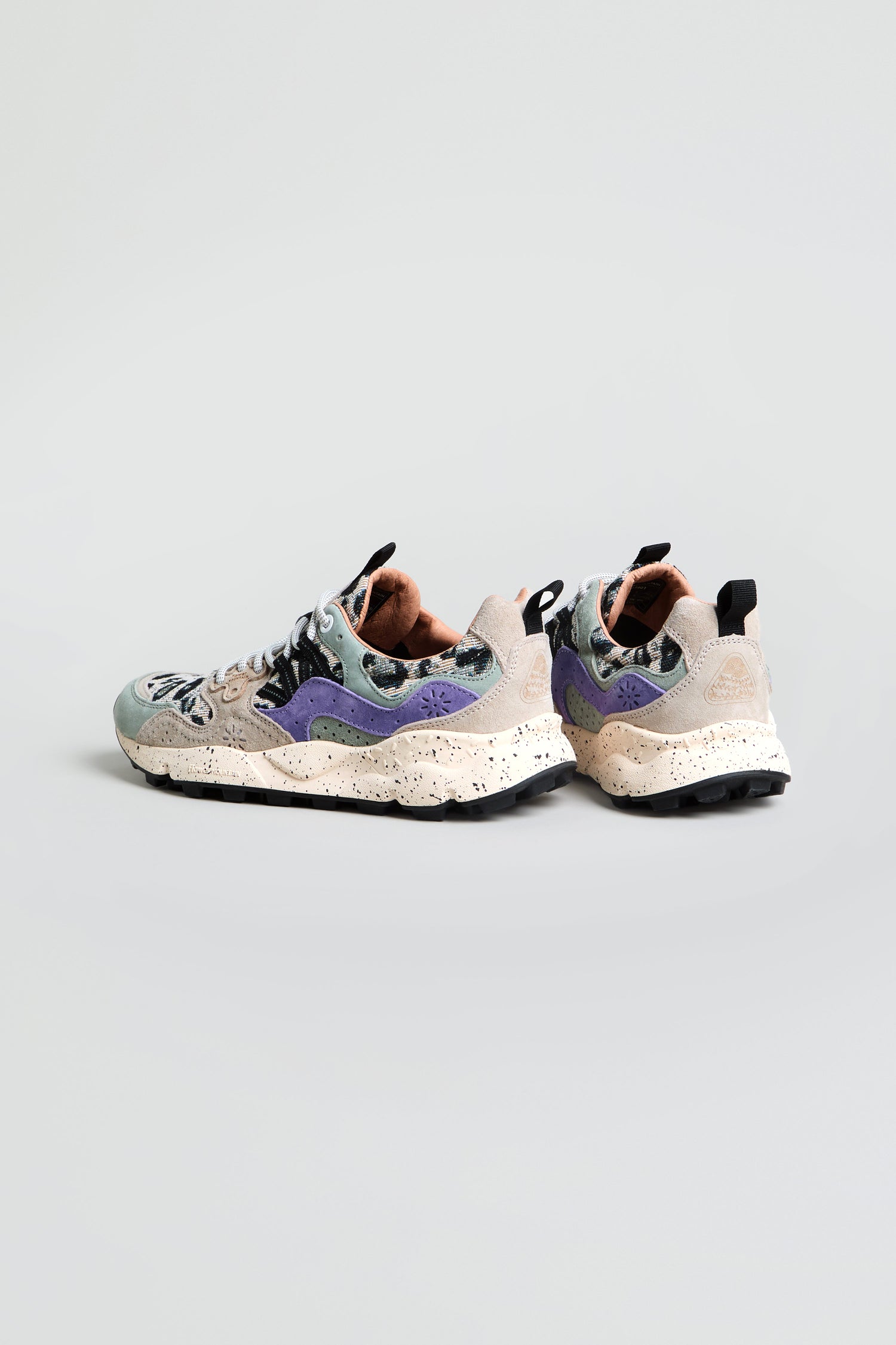 A pair of Yamano 3 Leopard Print Trainers featuring multicolored suede, speckled chunky soles, and purple side accents, positioned on a light gray background.