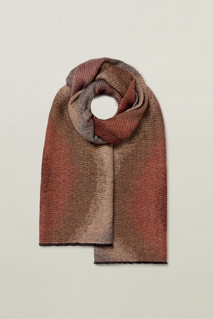 A Fraas Stardust Scarf, featuring a beautiful mix of earthy brown tones, is neatly folded on a light background.