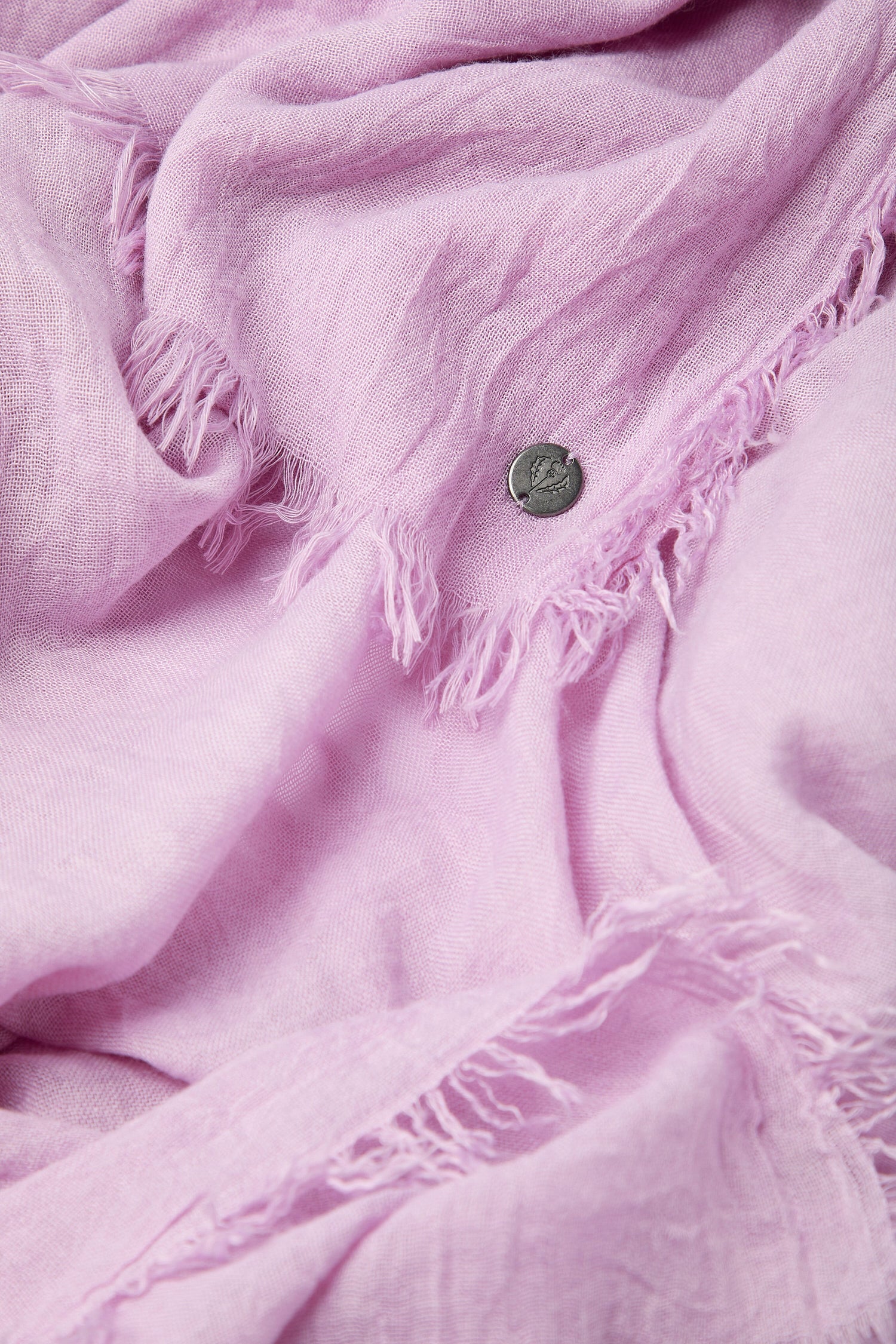 Pink Soft Fringe Scarf with frayed edges and a coin for scale.