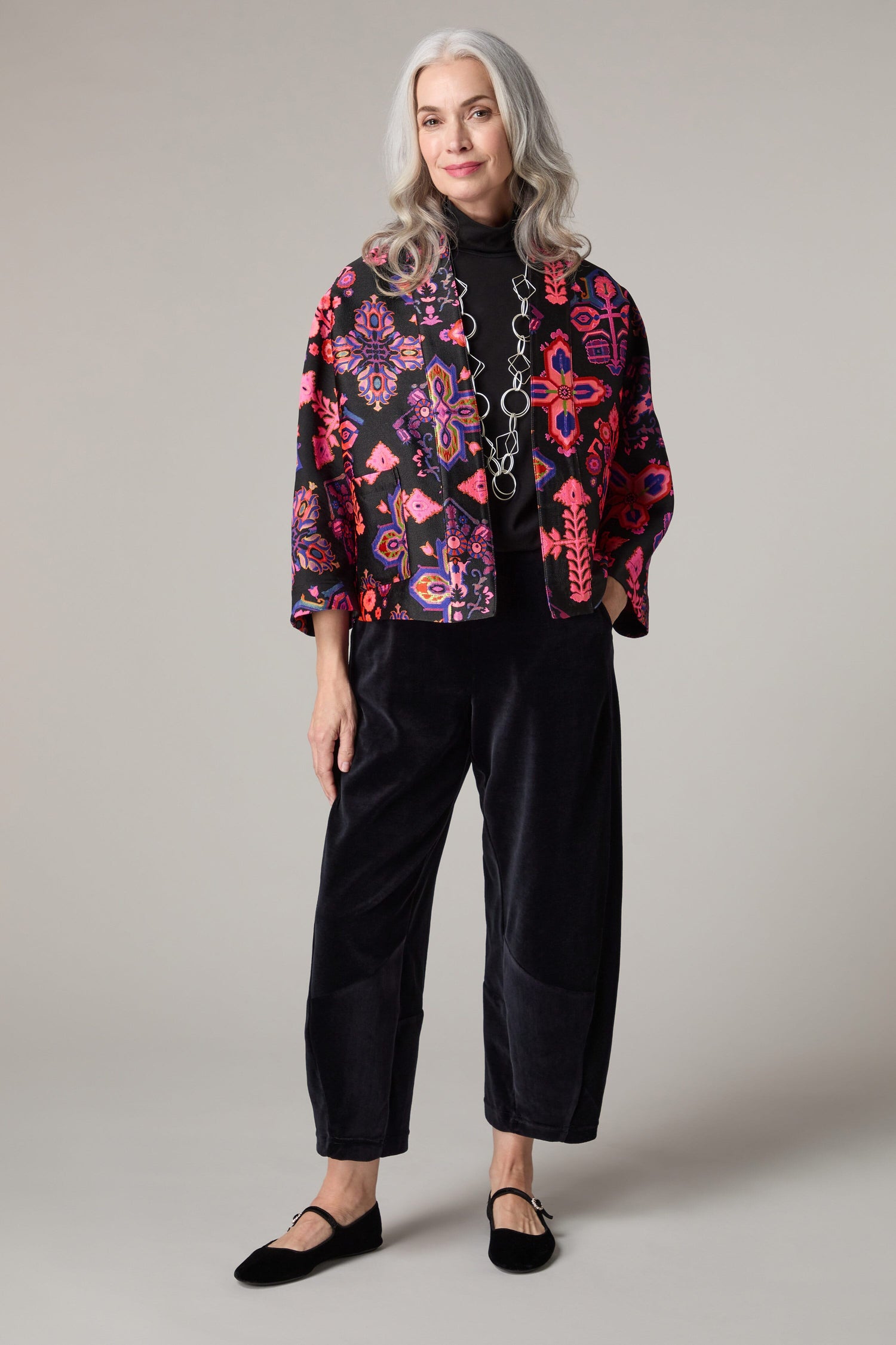 A woman with a boxy shape wearing a Jacquard Aztec Floral Jacket.