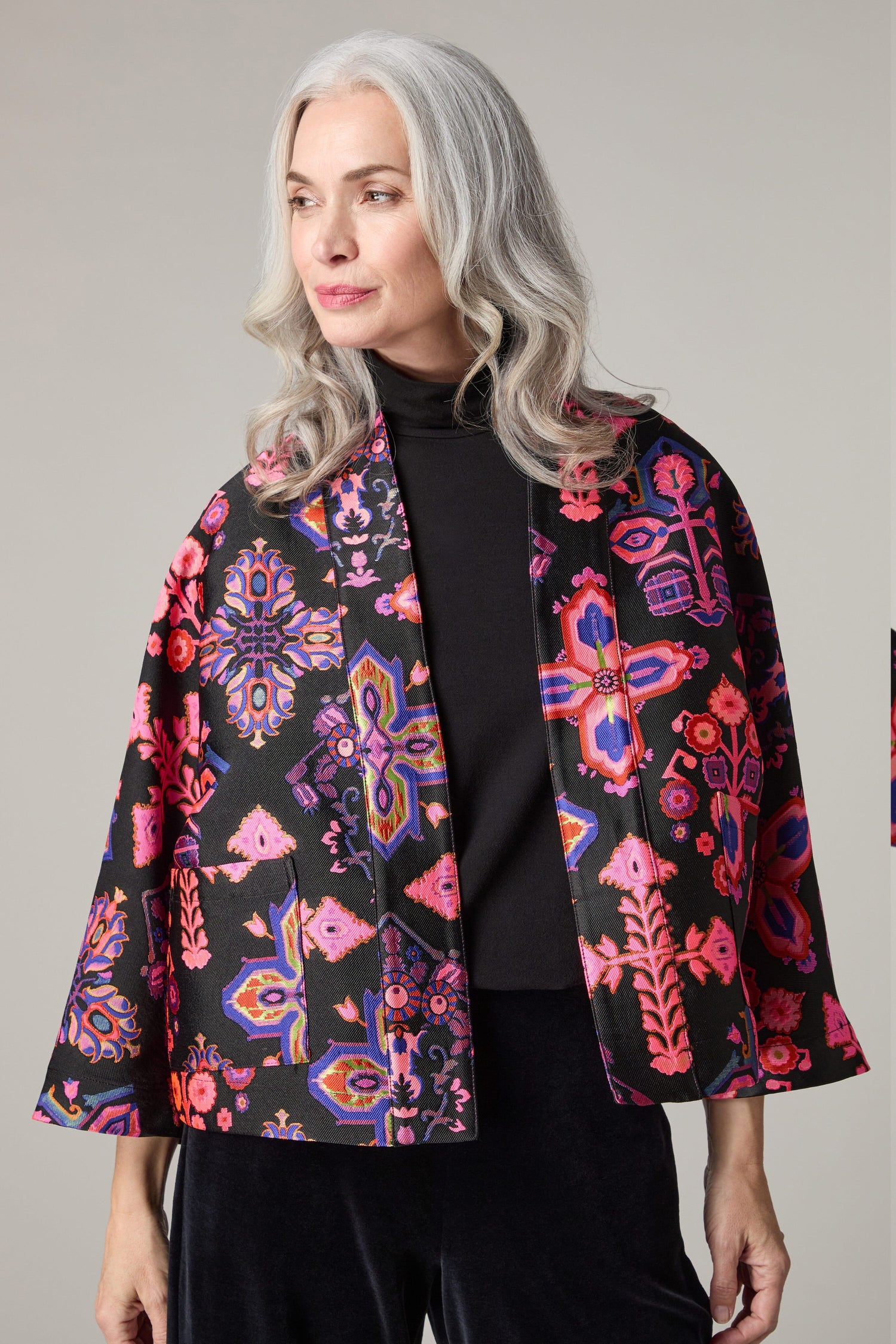 A woman wearing a Jacquard Aztec Floral Jacket woven into the fabric.