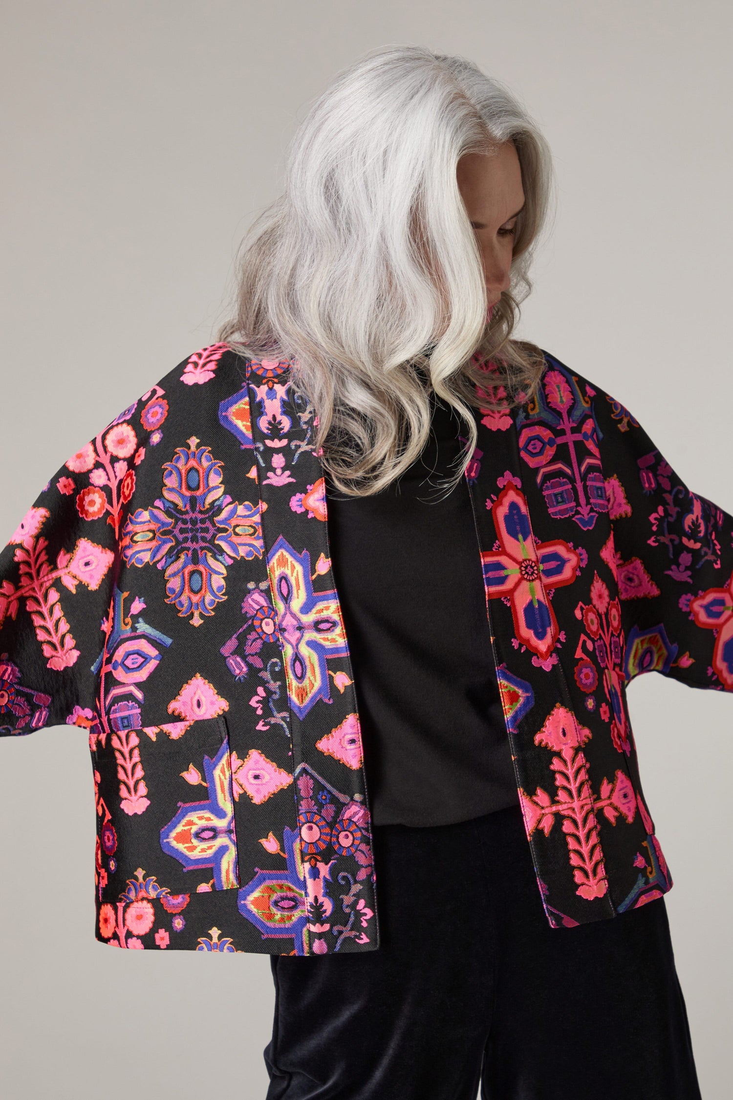 An older woman wearing a Jacquard Aztec Floral Jacket.