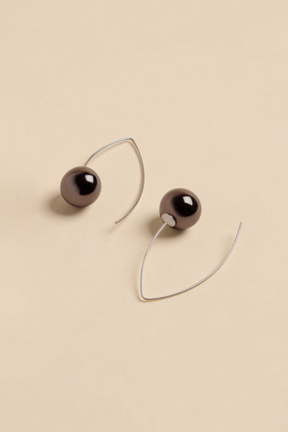 Handmade Charcoal Ceramic Bead Earrings featuring dark, spherical ceramic beads on curved silver-toned wires.