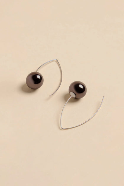 Handmade Charcoal Ceramic Bead Earrings suspended on silver-toned wire hooks.