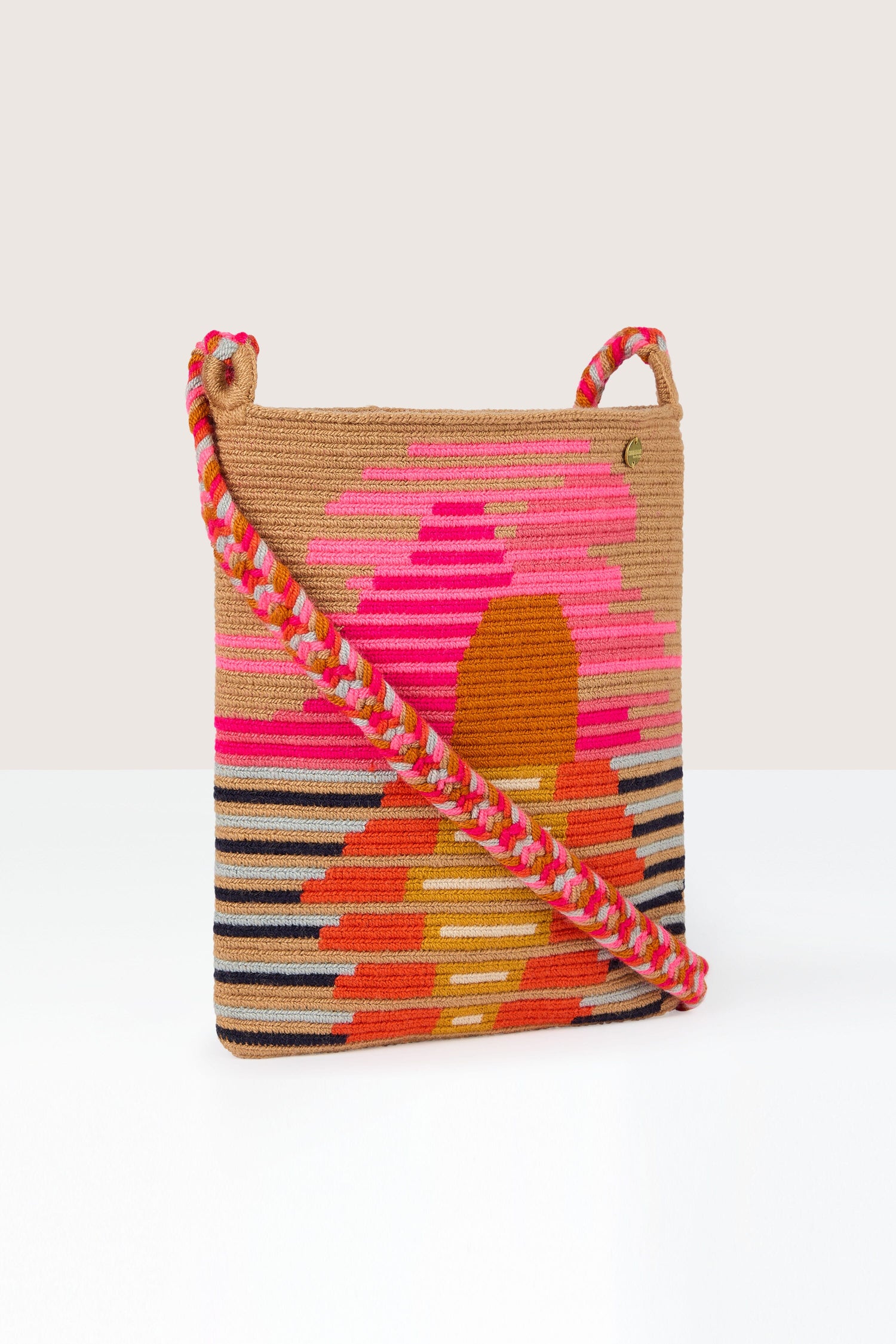 A Handcrafted Rectangular Crossbody Bag with a colorful, geometric pattern and braided strap, featuring vibrant shades of pink, orange, red, yellow, and black. Skillfully made using traditional techniques.